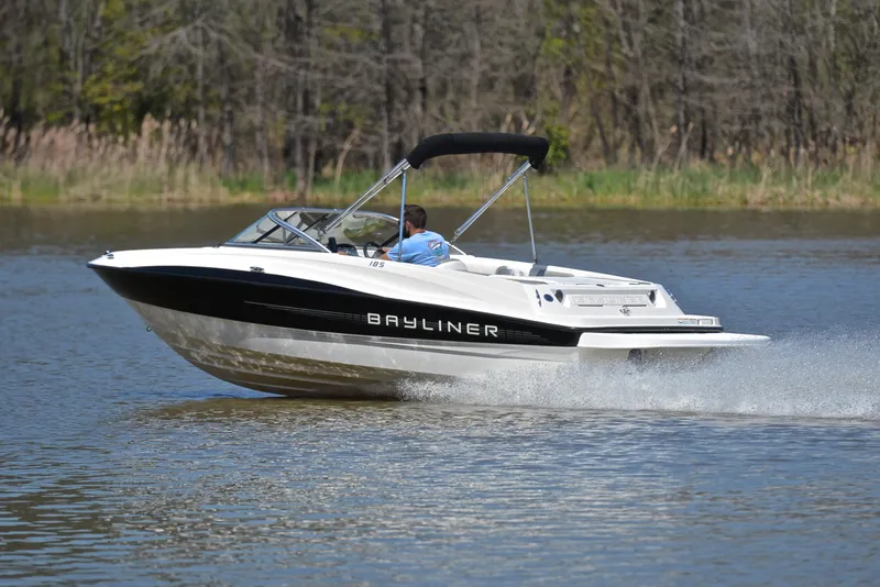 Slide: The Image of 2013 Bayliner 185 boat cruising on a lake. - 4