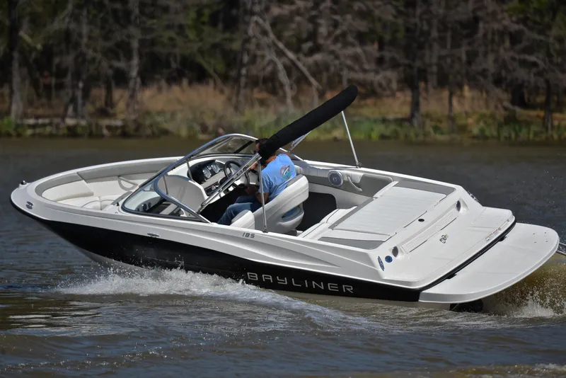 Slide: The Image of 2013 Bayliner 185 boat cruising on a lake. - 6