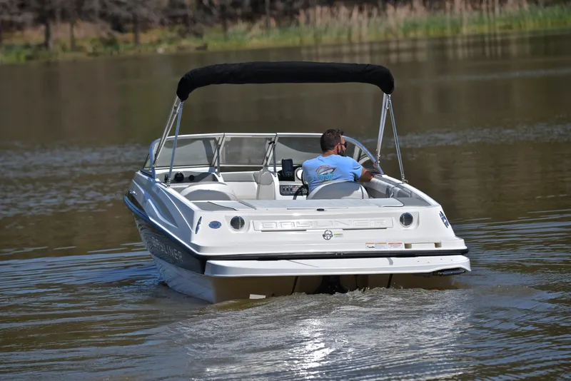 Slide: The Image of 2013 Bayliner 185 boat cruising on a calm lake. - 8