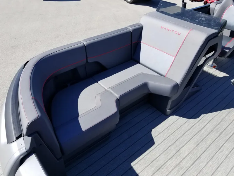 Slide: The Image of 2024 Manitou Explorer 22 Max Bench, gray seating with red accents. - 11