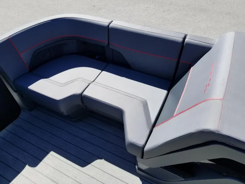 Slide: The Image of 2024 Manitou Explorer 22 Max Bench with sleek gray seating and red stitching. - 14