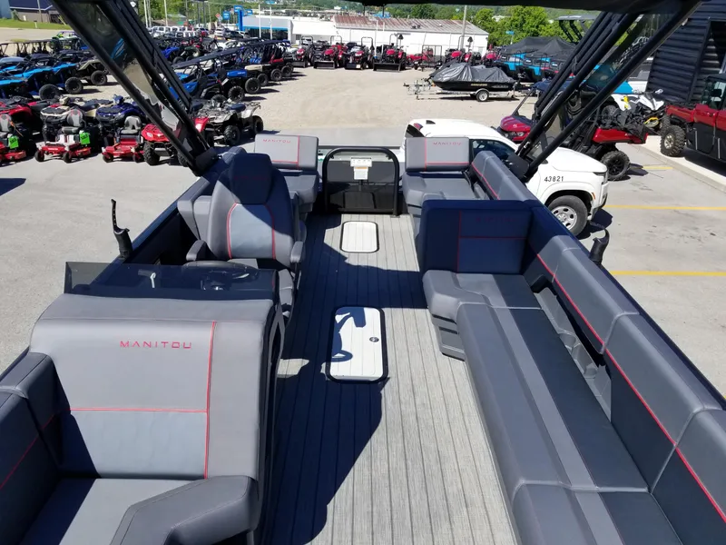 Slide: The Image of 2024 Manitou Explorer 22 Max Bench pontoon boat with spacious seating and modern design. - 15