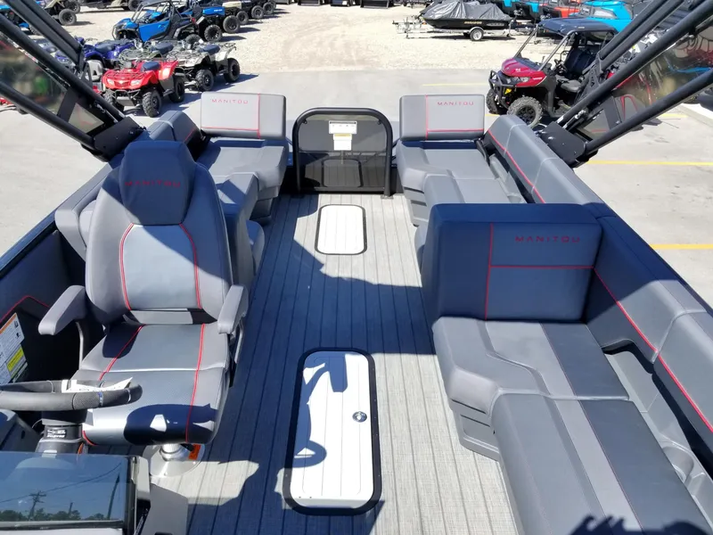 Slide: The Image of 2024 Manitou Explorer 22 Max Bench pontoon boat with spacious seating and modern design. - 16