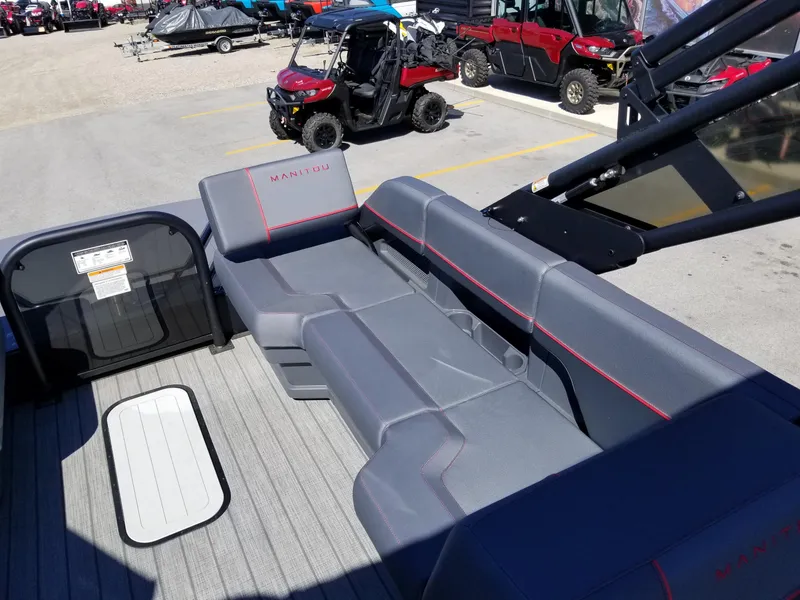 Slide: The Image of 2024 Manitou Explorer 22 Max Bench interior with gray seating and red accents. - 18