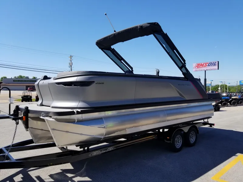 Slide: The Image of 2024 Manitou Explorer 22 Max Bench pontoon boat on a trailer. - 5