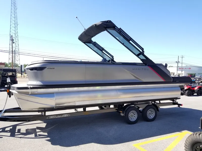Slide: The Image of 2024 Manitou Explorer 22 Max Bench pontoon boat on trailer. - 6