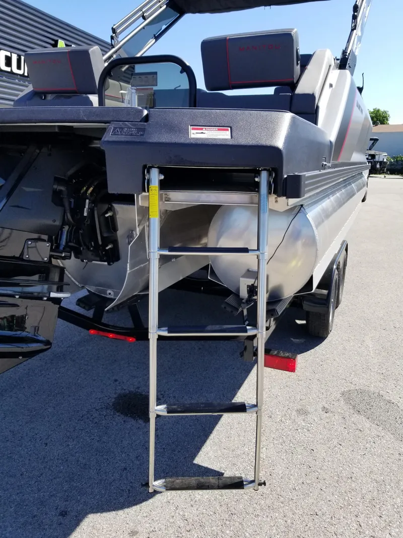 Slide: The Image of 2024 Manitou Explorer 22 Max Bench pontoon boat with rear ladder. - 8