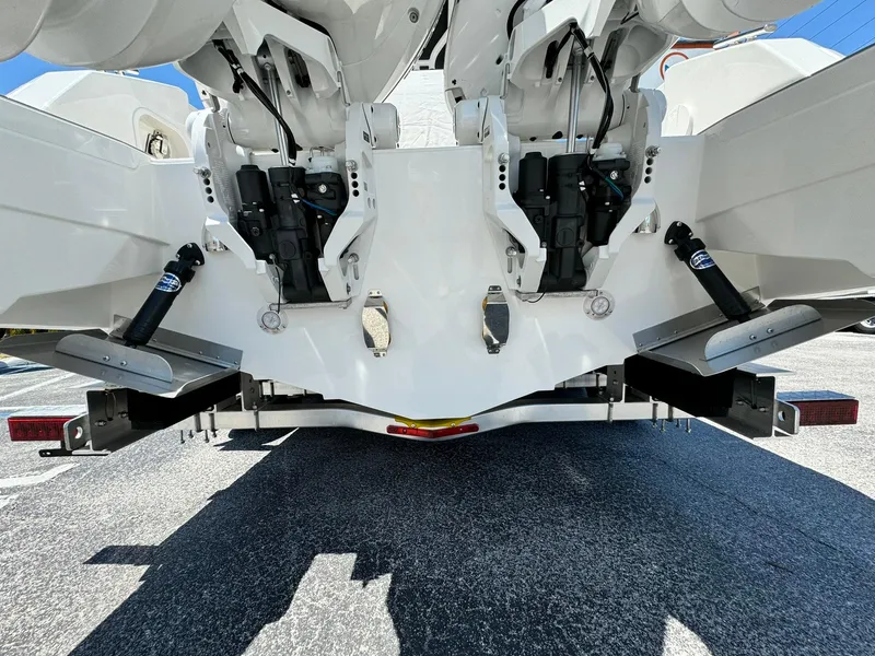 Slide: The Image of 2024 Windy SR28 CC boat stern with dual outboard engines and trim tabs. - 6