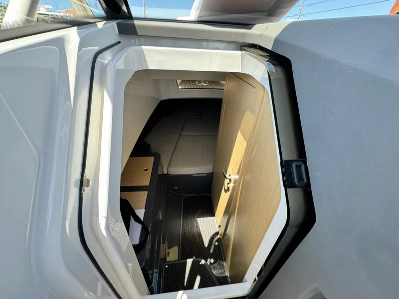 Slide: The Image of Interior cabin of 2024 Windy SR28 CC boat with wooden door and modern design. - 27