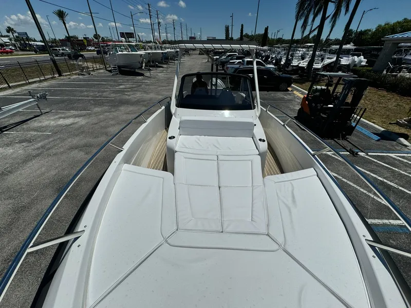 Slide: The Image of 2024 Windy SR28 CC boat with spacious deck and seating in a marina. - 24