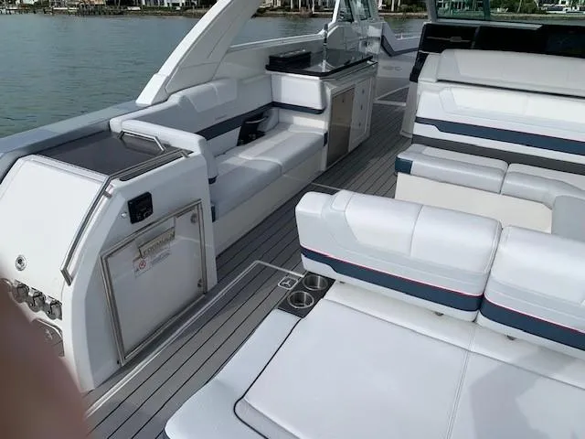 Slide: The Image of 2021 Formula 380 Super Sport Crossover OB interior with white seating and modern amenities. - 11