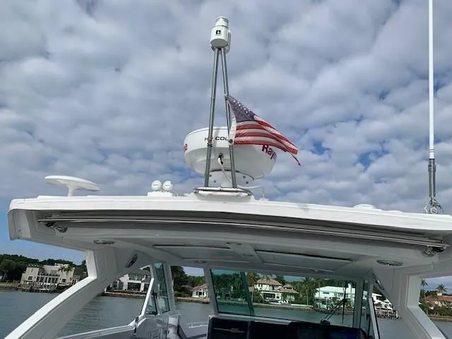 Slide: The Image of 2021 Formula 380 Super Sport Crossover OB boat with radar and American flag. - 12