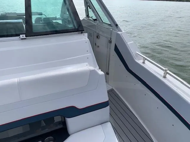 Slide: The Image of 2021 Formula 380 Super Sport Crossover OB boat interior with seating and deck view. - 15