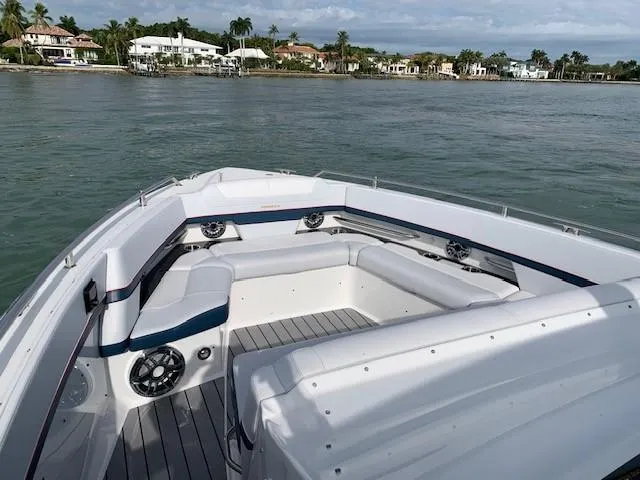 Slide: The Image of 2021 Formula 380 Super Sport Crossover OB boat with spacious seating on calm waters. - 2