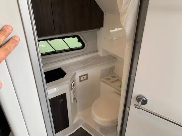 Slide: The Image of 2021 Formula 380 Super Sport Crossover OB bathroom with modern fixtures and window. - 21