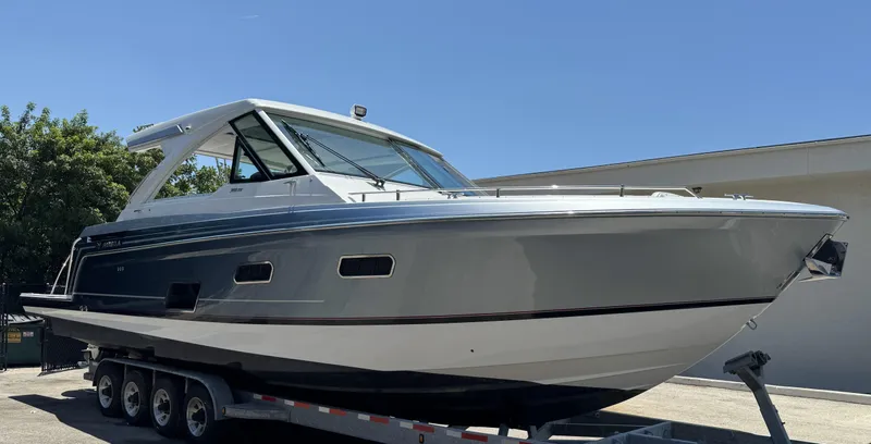 Slide: The Image of 2021 Formula 380 Super Sport Crossover OB boat on a trailer. - 26