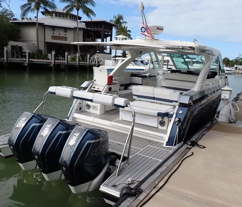 Slide: The Image of 2021 Formula 380 Super Sport Crossover OB docked, featuring triple outboard engines. - 34