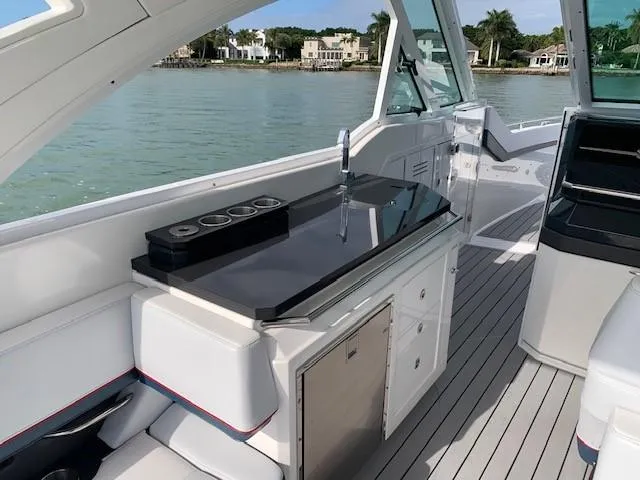 Slide: The Image of 2021 Formula 380 Super Sport Crossover OB boat interior with kitchenette and waterfront view. - 6