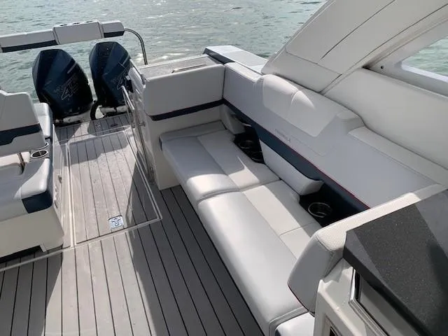 Slide: The Image of 2021 Formula 380 Super Sport Crossover OB, spacious seating area, dual outboard engines, luxury boat interior. - 7