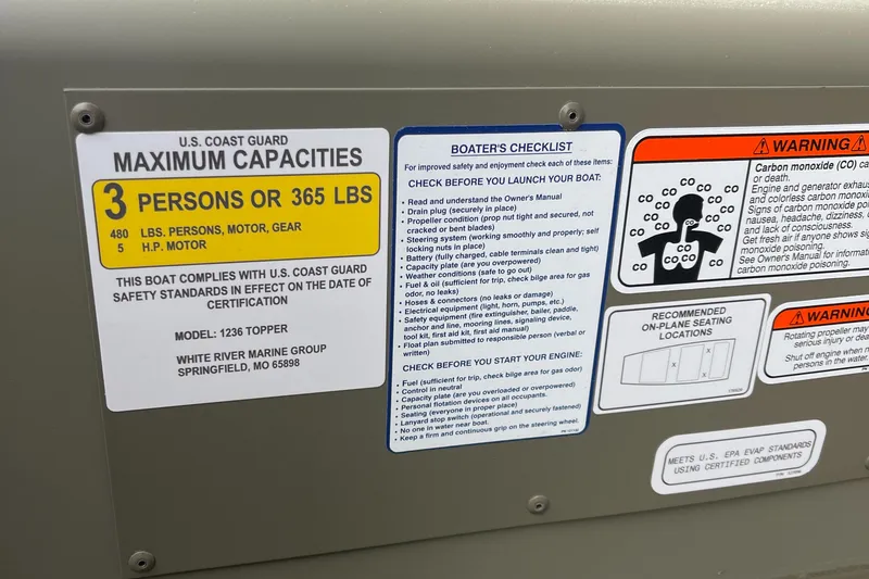 Slide: The Image of 2024 Tracker Grizzly 1236 Jon boat capacity and safety labels. - 3