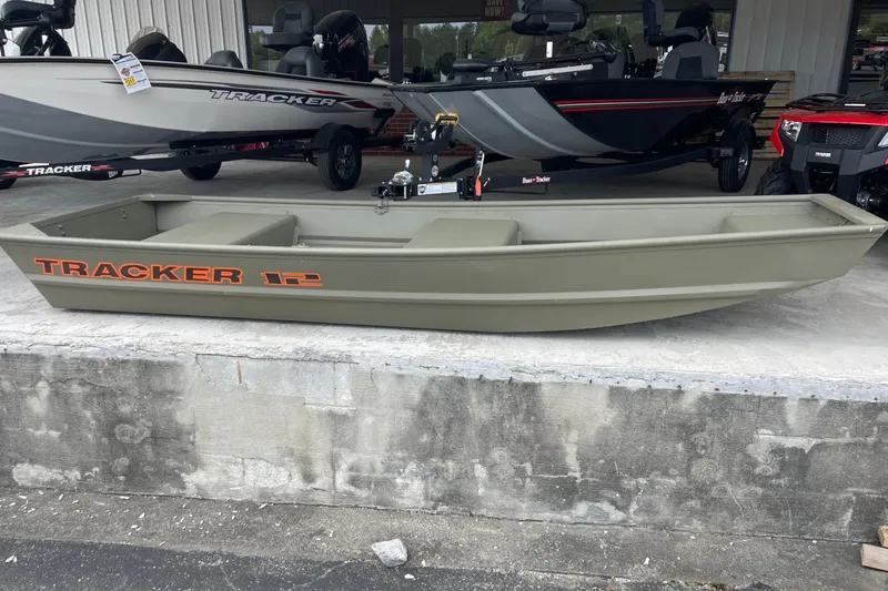Slide: The Image of 2024 Tracker Grizzly 1236 Jon boat displayed outdoors. - 4
