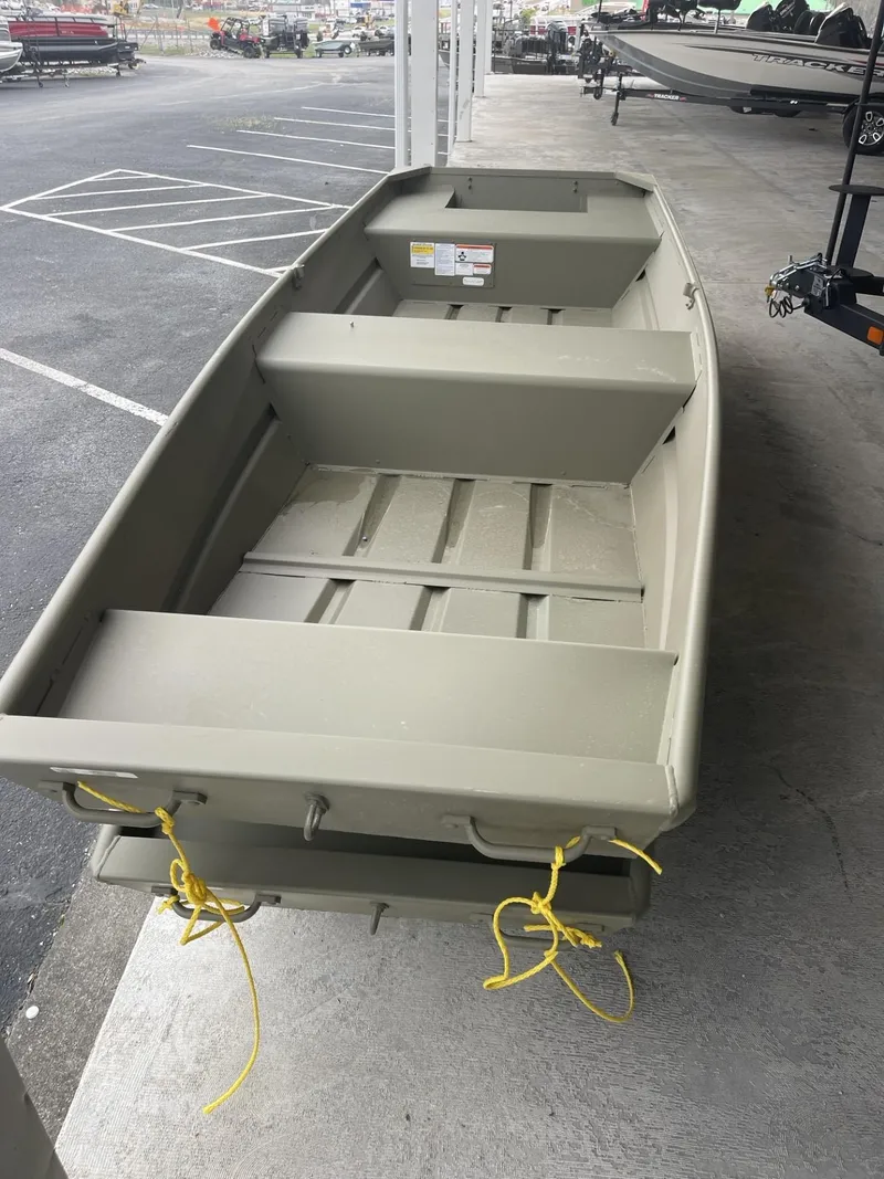 Slide: The Image of 2024 Tracker Grizzly 1436 Jon boat in a parking lot. - 2