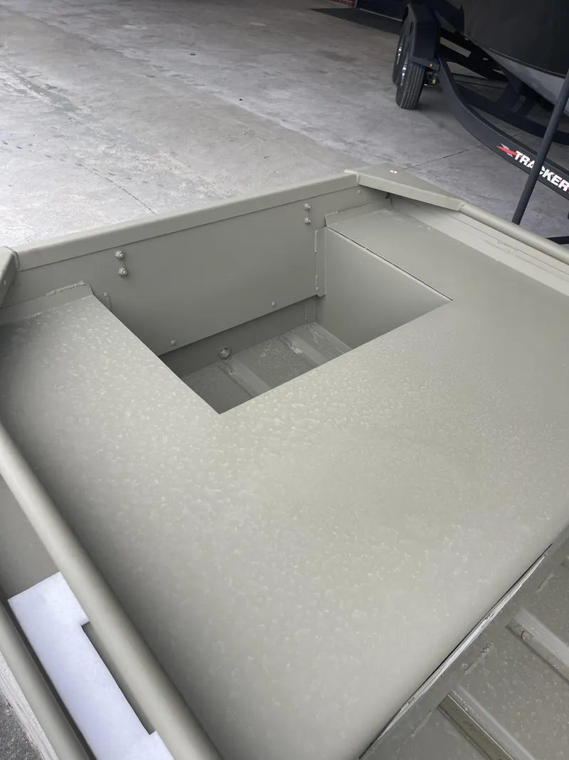 Slide: The Image of 2024 Tracker Grizzly 1436 Jon boat interior, showing storage compartment. - 4
