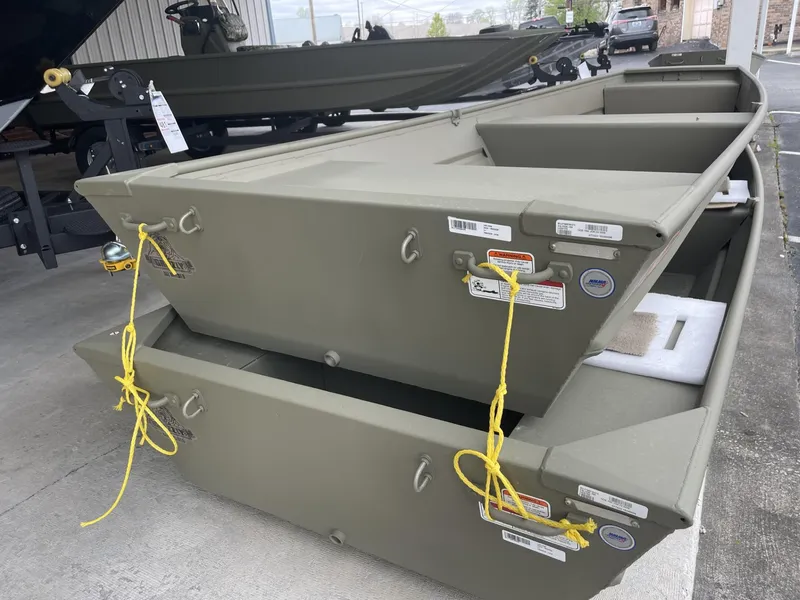 Slide: The Image of 2024 Tracker Grizzly 1436 Jon boat in showroom, olive green, stacked display. - 5