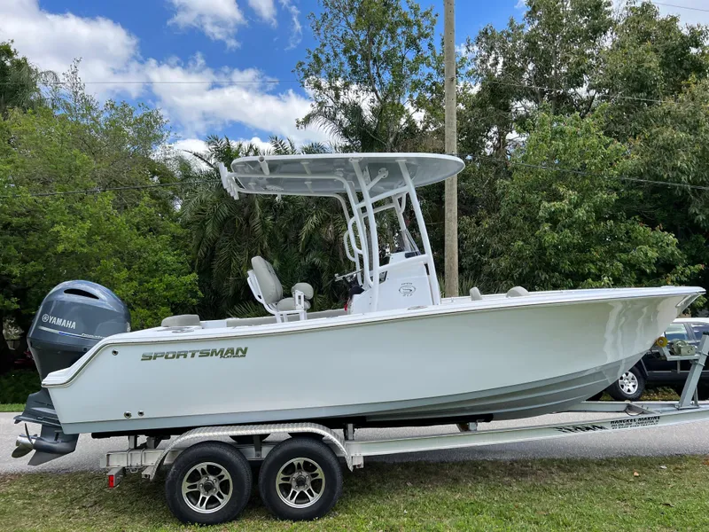 Slide: The Image of 2023 Sportsman Open 212 Platinum boat on a trailer with Yamaha outboard motor. - 1