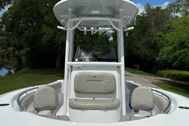 Slide: The Image of 2023 Sportsman Open 212 Platinum boat with cushioned seating and T-top. - 11