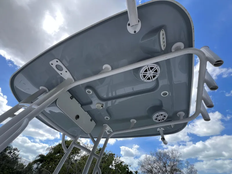 Slide: The Image of 2023 Sportsman Open 212 Platinum boat T-top with speakers and rod holders. - 13