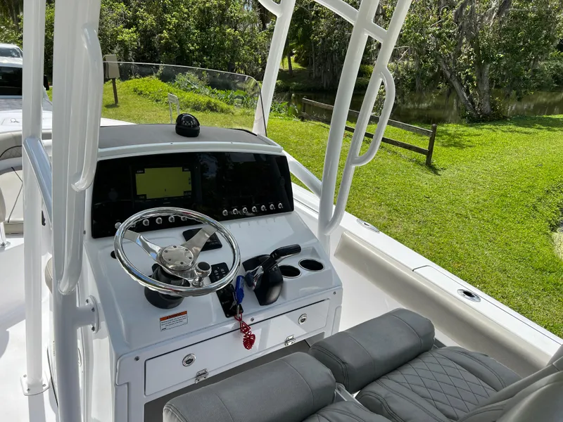 Slide: The Image of 2023 Sportsman Open 212 Platinum boat console with steering wheel and navigation system. - 14