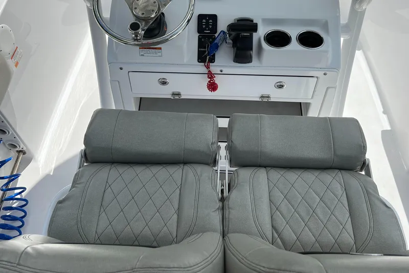 Slide: The Image of 2023 Sportsman Open 212 Platinum boat cockpit with dual seats and steering console. - 15