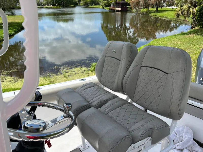 Slide: The Image of 2023 Sportsman Open 212 Platinum boat seats with lake view. - 16