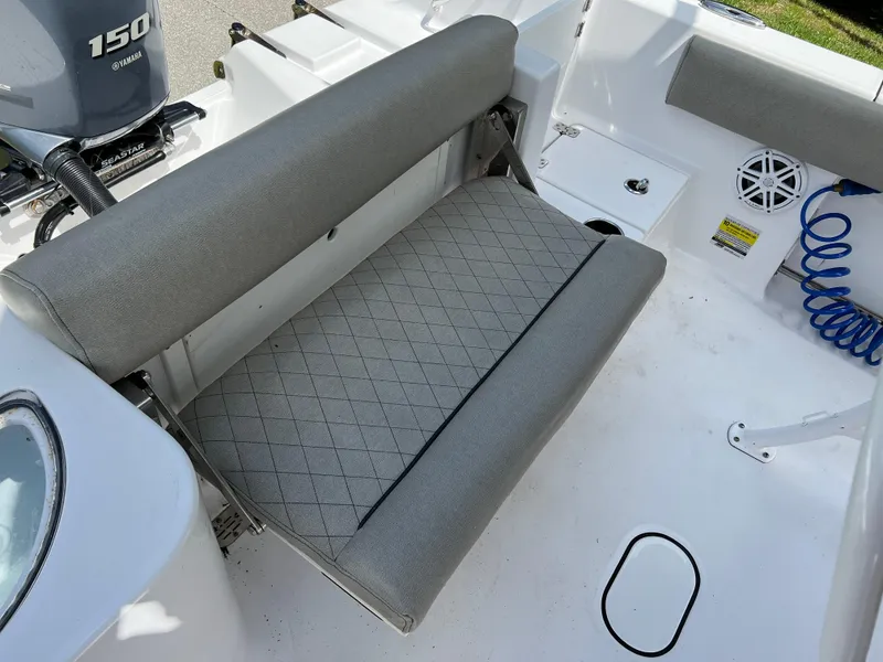 Slide: The Image of 2023 Sportsman Open 212 Platinum boat with cushioned seating and Yamaha 150 engine. - 21