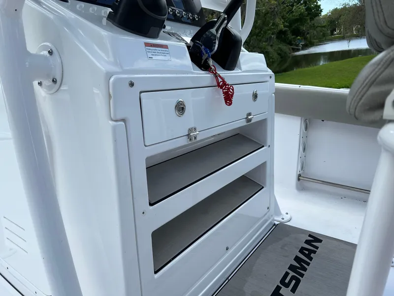 Slide: The Image of 2023 Sportsman Open 212 Platinum boat console with storage compartments. - 22