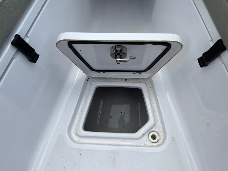 Slide: The Image of 2023 Sportsman Open 212 Platinum boat storage compartment with open hatch. - 24