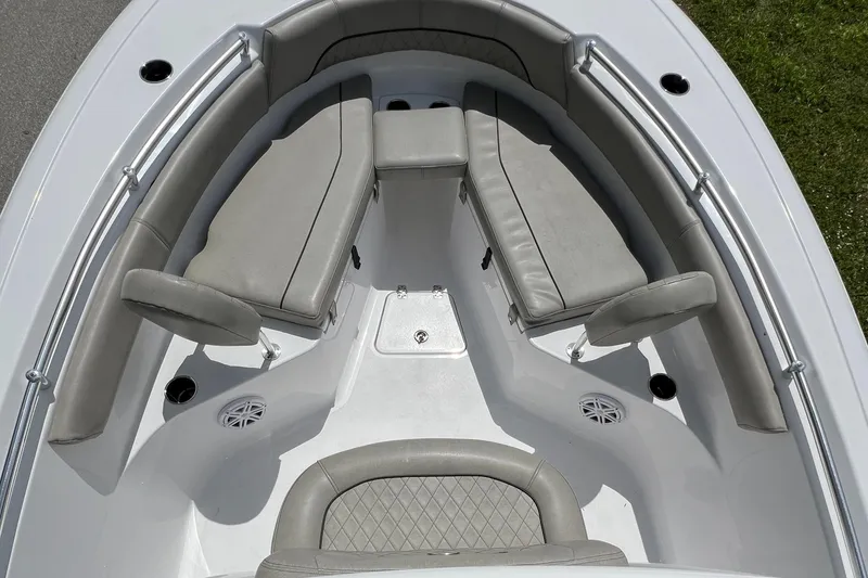 Slide: The Image of 2023 Sportsman Open 212 Platinum boat interior with cushioned seating and speakers. - 27