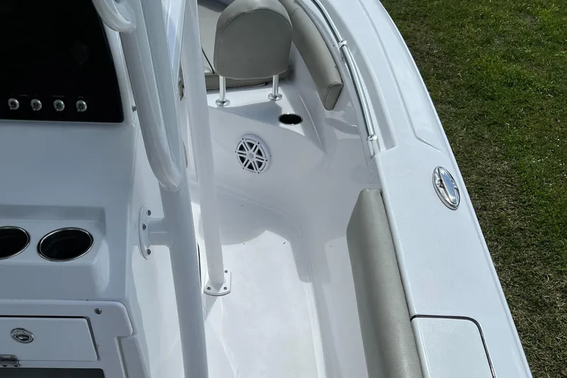 Slide: The Image of 2023 Sportsman Open 212 Platinum boat interior, white deck with seating and cup holders. - 30