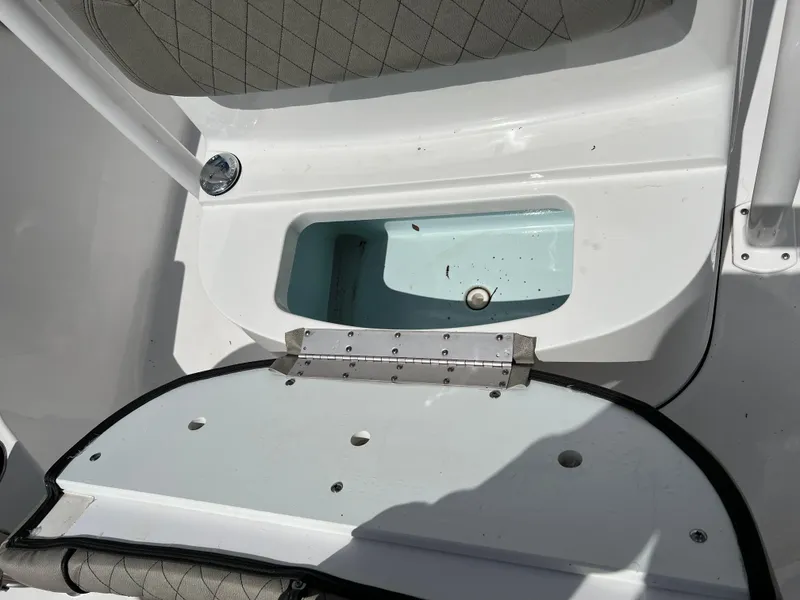 Slide: The Image of 2023 Sportsman Open 212 Platinum boat storage compartment with open lid. - 31