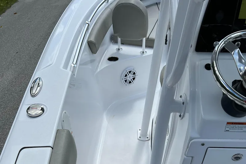 Slide: The Image of 2023 Sportsman Open 212 Platinum boat interior with seating and steering wheel. - 32