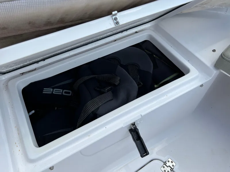 Slide: The Image of 2023 Sportsman Open 212 Platinum storage compartment with life jackets. - 33