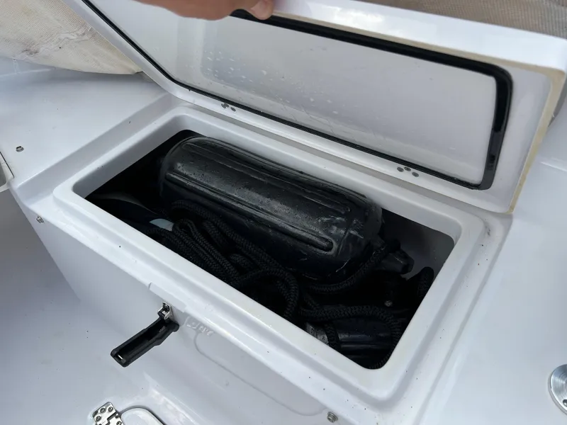 Slide: The Image of Storage compartment of 2023 Sportsman Open 212 Platinum boat with fender and ropes. - 34