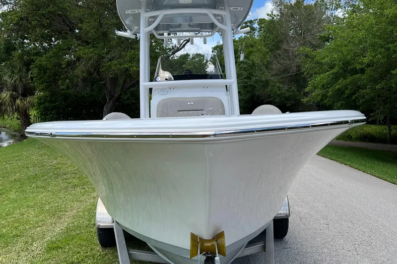 Slide: The Image of 2023 Sportsman Open 212 Platinum boat on a trailer, front view. - 8