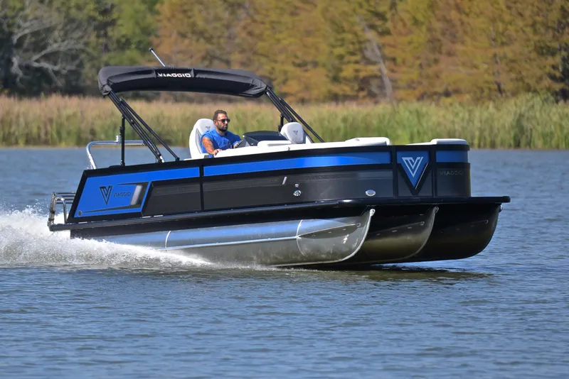 Slide: The Image of 2023 Viaggio D23S Platinum pontoon boat cruising on a lake. - 1