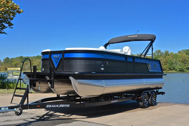 Slide: The Image of 2023 Viaggio D23S Platinum pontoon boat on a trailer by a lake. - 10