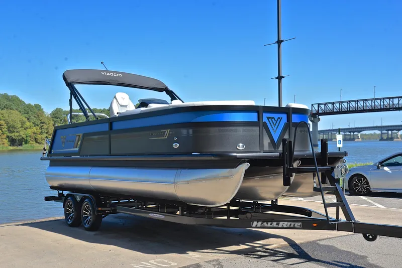 Slide: The Image of 2023 Viaggio D23S Platinum pontoon boat on trailer by the water. - 16