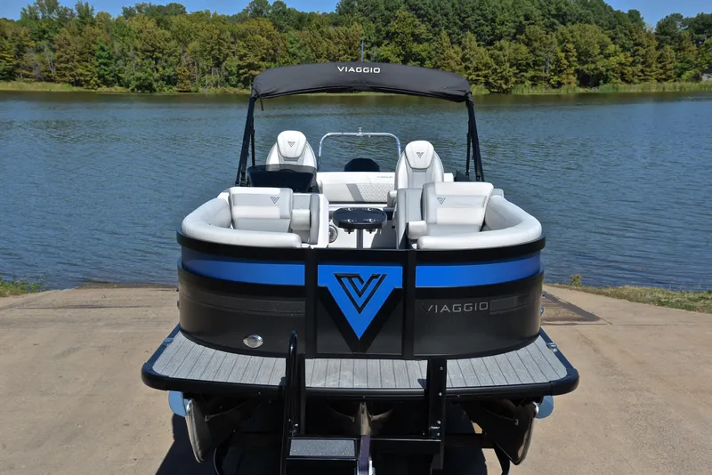 Slide: The Image of 2023 Viaggio D23S Platinum pontoon boat docked by a serene lake. - 17