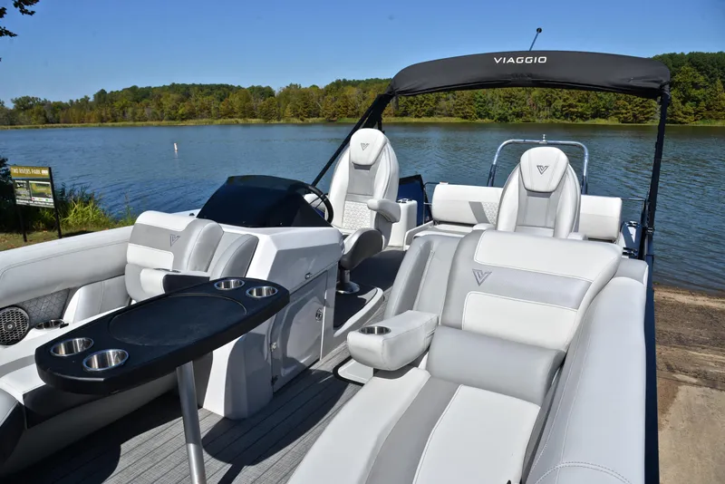 Slide: The Image of 2023 Viaggio D23S Platinum pontoon boat with luxurious seating on a serene lake. - 23