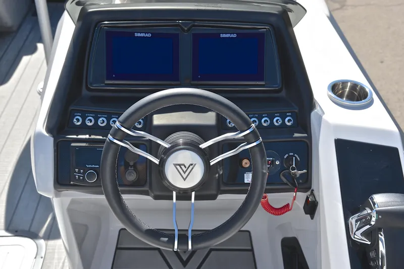 Slide: The Image of Viaggio D23S Platinum 2023 boat dashboard with steering wheel and dual Simrad displays. - 28